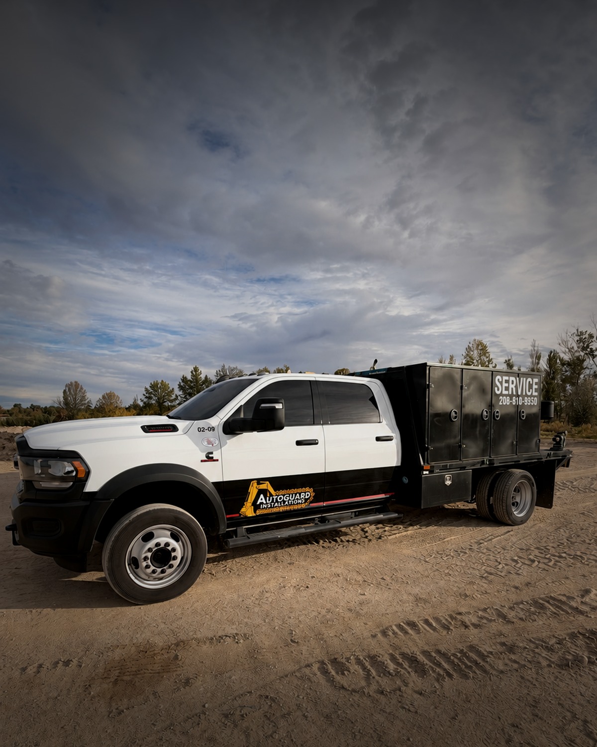 AutoGuard Installations service truck parked on a gravel jobsite